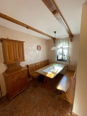 a kitchen with a wooden table and a window at APARTMA ARNIKA Rogla, Turistično naselje NUNE RESNIK, RESNIK 110 in Zreče