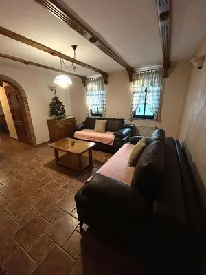 a living room with a couch and a table at APARTMA ARNIKA Rogla, Turistično naselje NUNE RESNIK, RESNIK 110 in Zreče