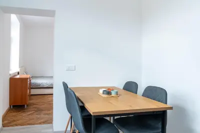 a dining room with a wooden table and chairs at Urban NEST apartment - FREE Parking & Central in Kočevje