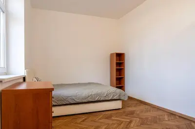 a bedroom with a bed and a book shelf at Urban NEST apartment - FREE Parking & Central in Kočevje