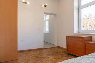 a bedroom with a bed and a dresser and a window at Urban NEST apartment - FREE Parking & Central in Kočevje