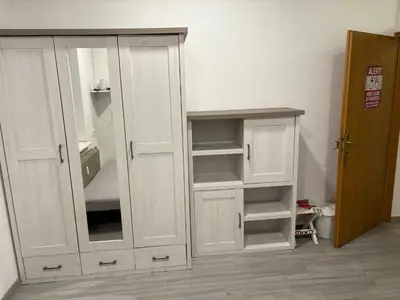 a white cabinet with a mirror in a room at Industrial studio 5 in Ljubljana