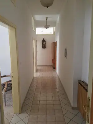 a hallway with white walls and a tile floor at Apartma Raft, Bovec in Bovec