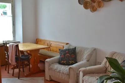 a living room with a table and a couch and a table and chairs at Apartma Raft, Bovec in Bovec