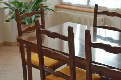 a dining room table with four chairs and a wooden table at Apartma Raft, Bovec in Bovec