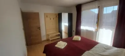 a bedroom with a bed with two towels on it at Apart House ROJER in Ljubno