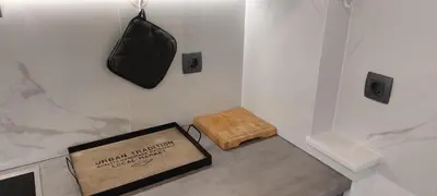 a room with a box and a bag on a wall at Apart House ROJER in Ljubno