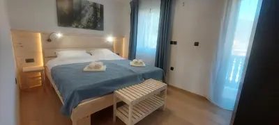 a bedroom with a bed with two towels on it at Apart House ROJER in Ljubno