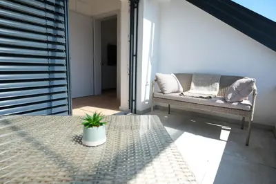 a living room with a couch and a table at Apartma Eva in Krško