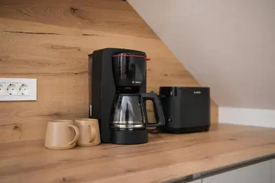 a black coffee maker sitting on a counter at Apartma Eva in Krško