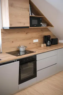 a kitchen with a stove and a microwave at Apartma Eva in Krško