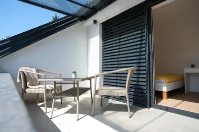 a patio with a table and chairs on a balcony at Apartma Eva in Krško