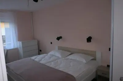 a bedroom with a white bed with two white pillows at Apartment Golovec in Ljubljana