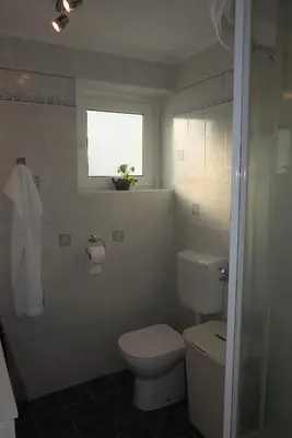 a bathroom with a toilet and a window at Apartment Golovec in Ljubljana