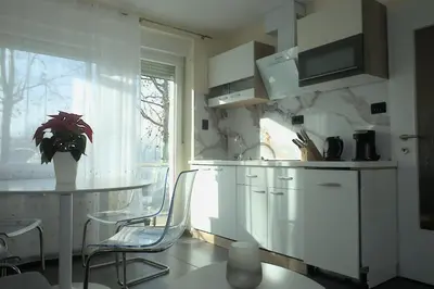 a kitchen with a table and chairs and a window at Apartment Golovec in Ljubljana