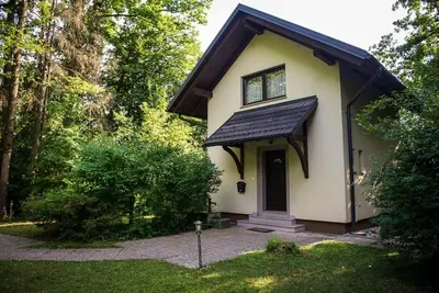 a small white house with a window and a door at Holiday Home Lemut in Kranj