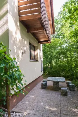a patio with a picnic table and a wooden deck at Holiday Home Lemut in Kranj