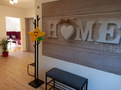 a room with a wooden wall with a heart sign at Apartma Melita in Rovte