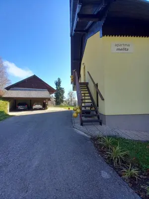 a building with a staircase on the side of it at Apartma Melita in Rovte