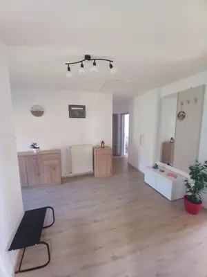 an empty living room with a chair and a table at Apartma Melita in Rovte