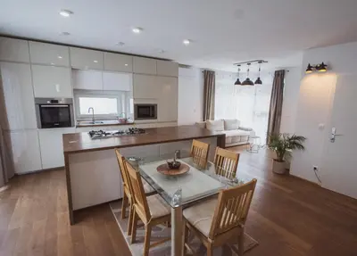 a kitchen and dining room with a glass table and chairs at PR`FIK Apartments in Kranj