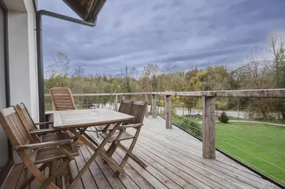 a wooden deck with a table and chairs on it at PR`FIK Apartments in Kranj