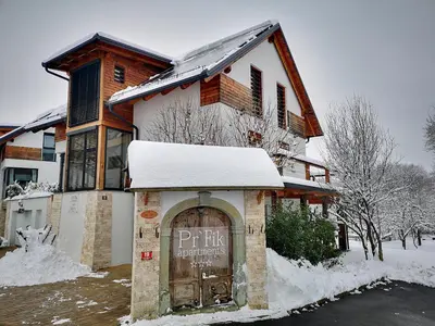 a house with a sign in front of it in the snow at PR`FIK Apartments in Kranj