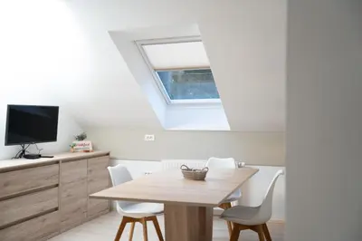 a dining room with a table and white chairs at Vila Vesna in Zgornje Gorje