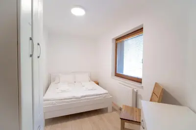 a small room with a bed and a window at Vila Vesna in Zgornje Gorje