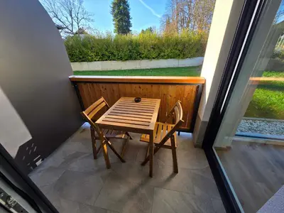 a small table and two chairs on a balcony at Vila Brod in Ljubljana
