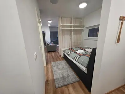 a small bedroom with a bed and a hallway at Vila Brod in Ljubljana