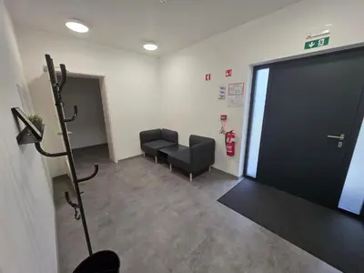 a waiting room with a black door and a fire hydrant at Vila Brod in Ljubljana