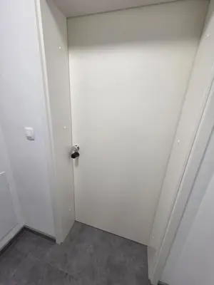 an empty room with a white door in a room at Vila Brod in Ljubljana