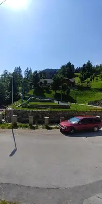 a red car is driving down a street at Apartment Tarman in Jesenice