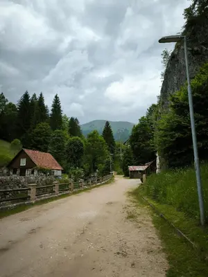 a dirt road with a house on the side of the road at Apartment Tarman in Jesenice