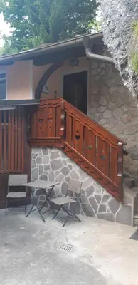 a table and chairs in front of a building at Apartment Tarman in Jesenice