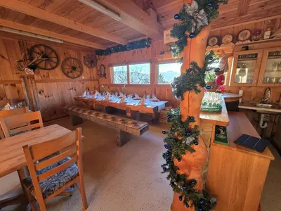 a dining room with wooden tables and christmas decorations at Turistična kmetija Sušek in Muta