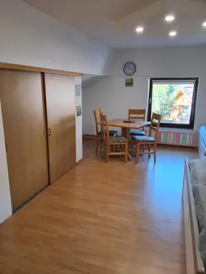 a room with a table and chairs and a dining room at Turistična kmetija Sušek in Muta