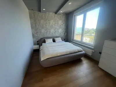 a small bedroom with a bed and a window at Stunning Terrace in Ljubljana