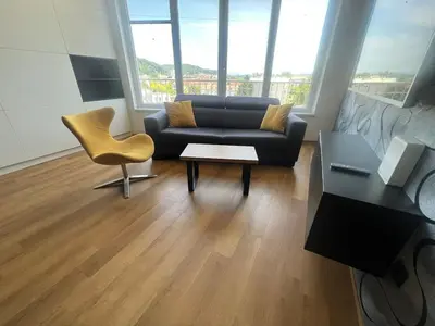 a living room with a couch and a chair at Stunning Terrace in Ljubljana