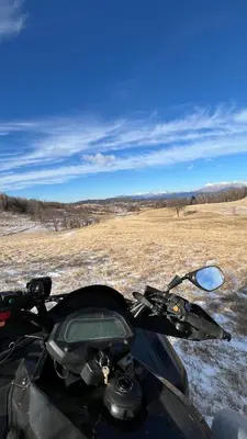a motorcycle parked in a snow covered field at Cosy house Na Robu in Grgar