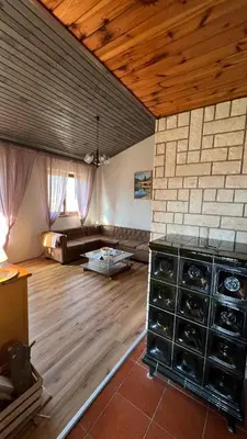 a large living room with wooden ceilings and a wooden floor at Cosy house Na Robu in Grgar