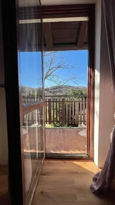 a sliding glass door with a view of a courtyard at Cosy house Na Robu in Grgar