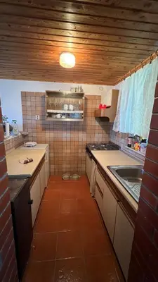 a small kitchen with a sink and a counter at Cosy house Na Robu in Grgar