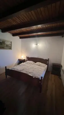 a bedroom with a large bed in a room at Cosy house Na Robu in Grgar