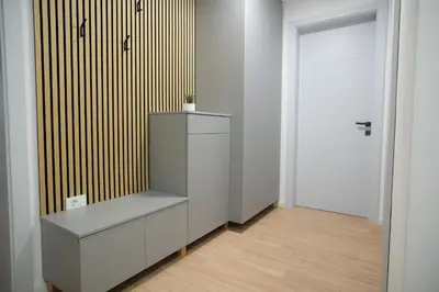 a white room with a shelf and a door at Apartma Ana in Krško