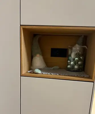 a cabinet with a shelf with various items in it at Mounti Alpine Studio in Kranjska Gora