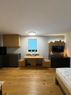 a large room with a desk and a window at Mounti Alpine Studio in Kranjska Gora