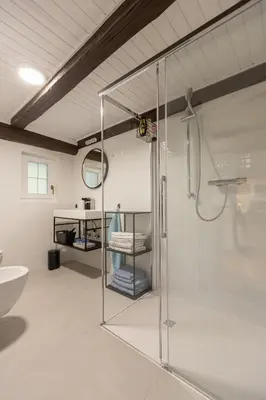 a bathroom with a glass shower and a sink at Hiša Jaglenka in Ponikva
