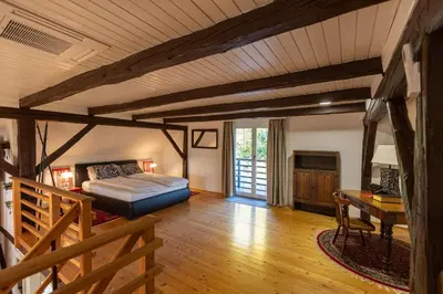 a bedroom with a bed and a desk in a room at Hiša Jaglenka in Ponikva